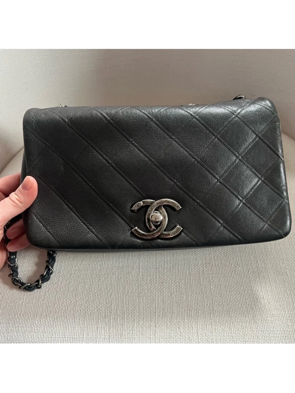 CHANEL Black Quilted Lambskin Shoulder Bag with Silver CC Lock.